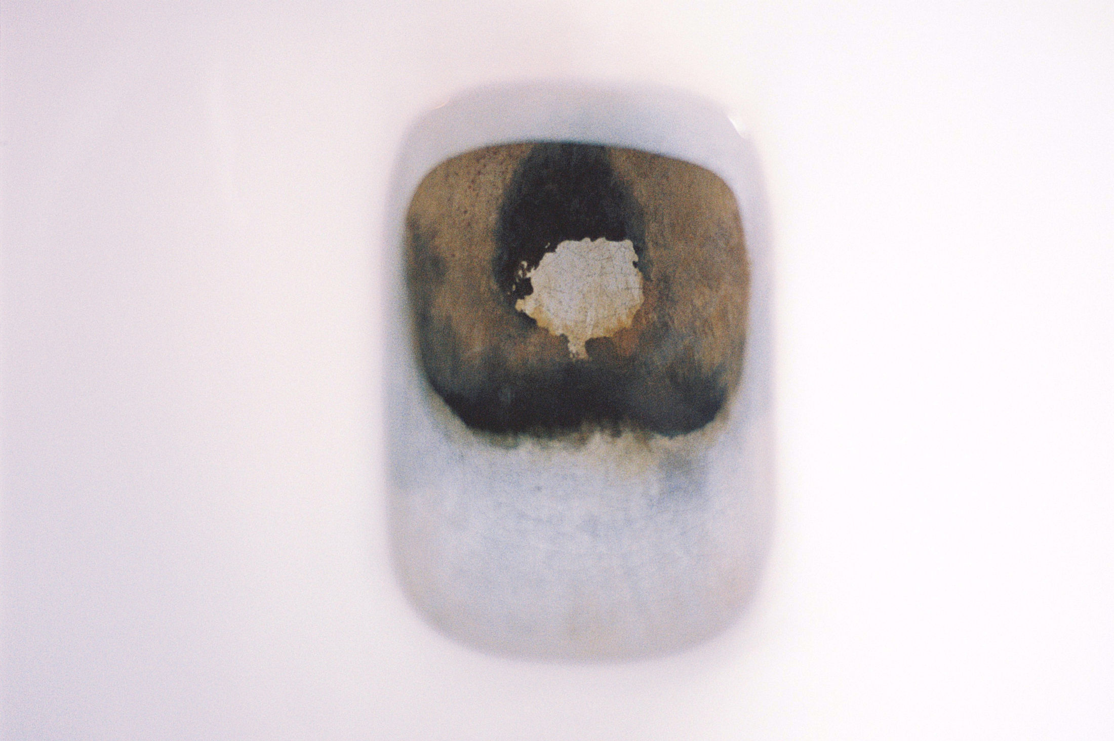 abstract art. Rusted bue oblong on white background