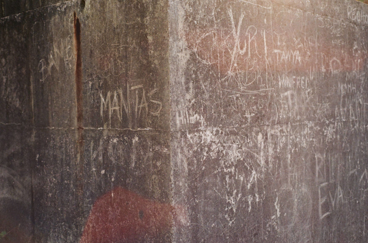 Photograph of names and dates carved in concrete structure